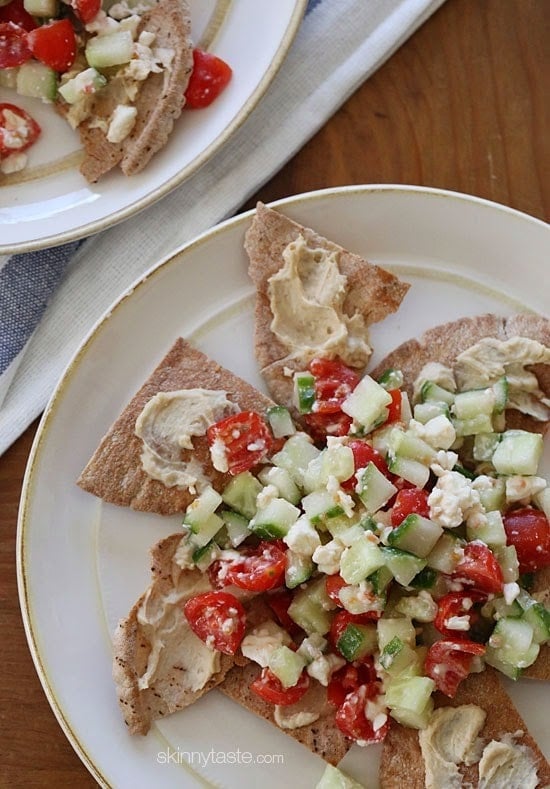 Greek Nachos A lighter, healthier Greek twist on traditional nachos – made with whole wheat pita chips, hummus, cucumbers, tomatoes and feta.