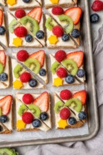 Overhead view of sugar cookie fruit pizza on sheet pan