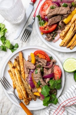 Two plates with Peruvian lomo saltado