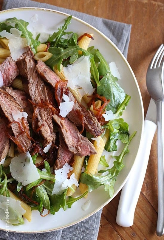 Grilled steak, arugula and pasta salad is topped with sweet balsamic caramelized onions and fresh shaved Parmesan. I'm a sucker for a good steak salad, and this one is AWESOME!