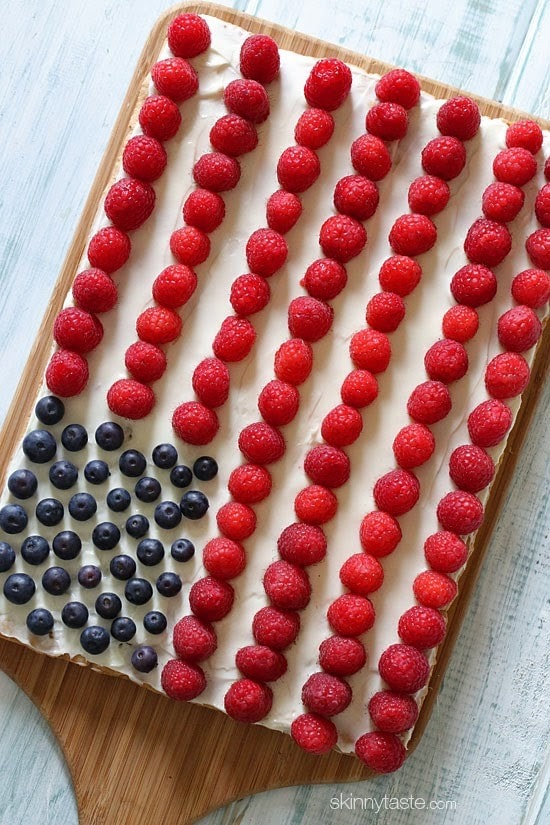 Red White + Blue Fruit Pizza Red, White and Blue fruit "pizza" is more like a cookie bar, topped with cream cheese frosting and fruit – The perfect 4th of July dessert!