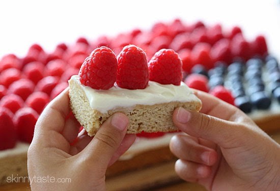 Red, White and Blue fruit "pizza" is more like a cookie bar, topped with cream cheese frosting and fruit – The perfect 4th of July dessert!