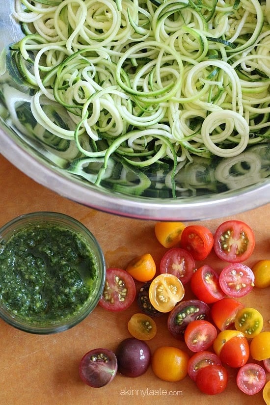Raw Spiralized Zucchini Noodles with Tomatoes and Pesto is my favorite easy, end-of-summer vegetarian dish made with raw, garden vegetables and homemade pesto.