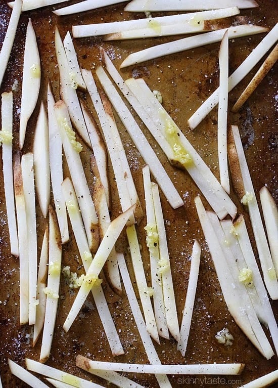 These delicious fries are baked in the oven with garlic, a little olive oil, kosher salt and black pepper, then sprinkled with freshly grated Parmesan and parsley – to die for!