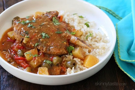 These slow cooker pork chops are seasoned with Latin spices in a flavorful sauce with tomatoes, olives, peppers and potatoes. They literally fall of the bone when they come out of the slow cooker!