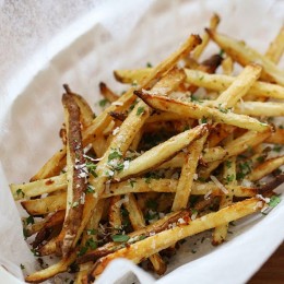 These delicious fries are baked in the oven with garlic, a little olive oil, kosher salt and black pepper, then sprinkled with freshly grated Parmesan and parsley – to die for!