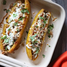 These sweet plantains are baked in the oven and then stuffed with a savory turkey picadillo filling and topped with cheese – pretty hard to resist!