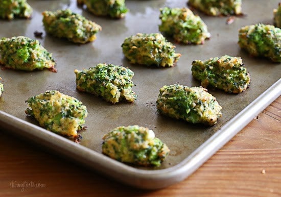 A baking sheet with cooked broccoli and cheese tots
