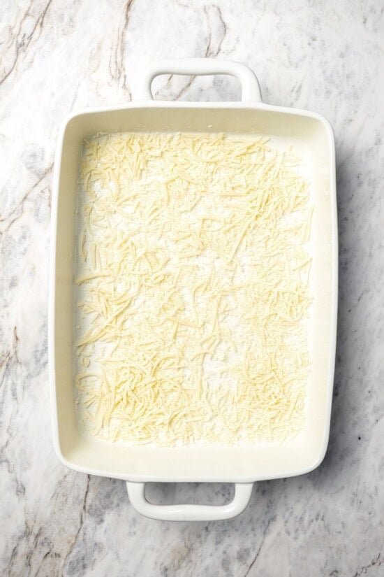 This healthy breakfast casserole recipe with sausage, cheese and veggies is hearty, flavorful, and perfect for meal prep or a weekend brunch! Shredded mozzarella in bottom of baking dish.