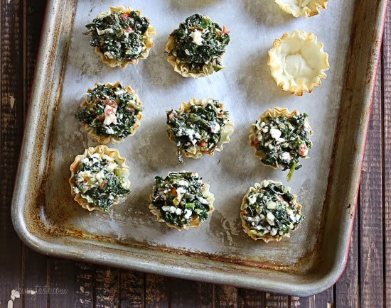 These bite-sized spinach pies are a fun twist on one of my favorite Greek dishes, Spanakopita. These are great appetizers for the Holidays, football games, or anytime you get together with friends and family.