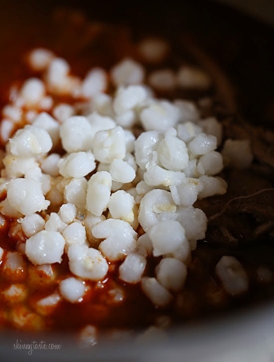 This Instant Pot Pozole Rojo recipe is easier and faster than the classic version! With pork, hominy and spices, it's hearty and flavorful. Hominy added to pozole rojo.