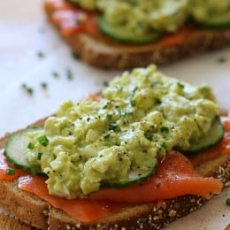 An open-faced egg salad sandwich with wild Nova salmon and cucumber slices – under 300 calories, protein packed, and loaded with good fats.