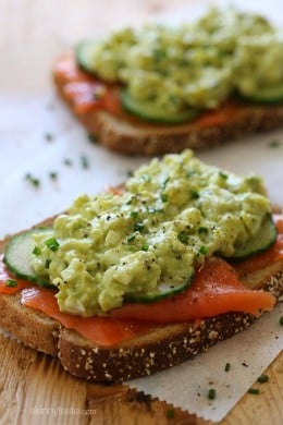 An open-faced egg salad sandwich with wild Nova salmon and cucumber slices – under 300 calories, protein packed, and loaded with good fats.