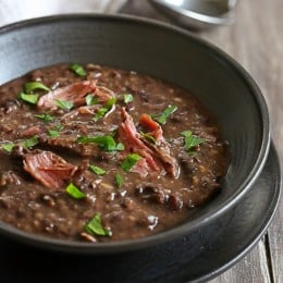 A black bowl of turkey bean soup