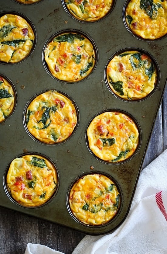 Baked petite mini crustless quiche in a muffin pan.