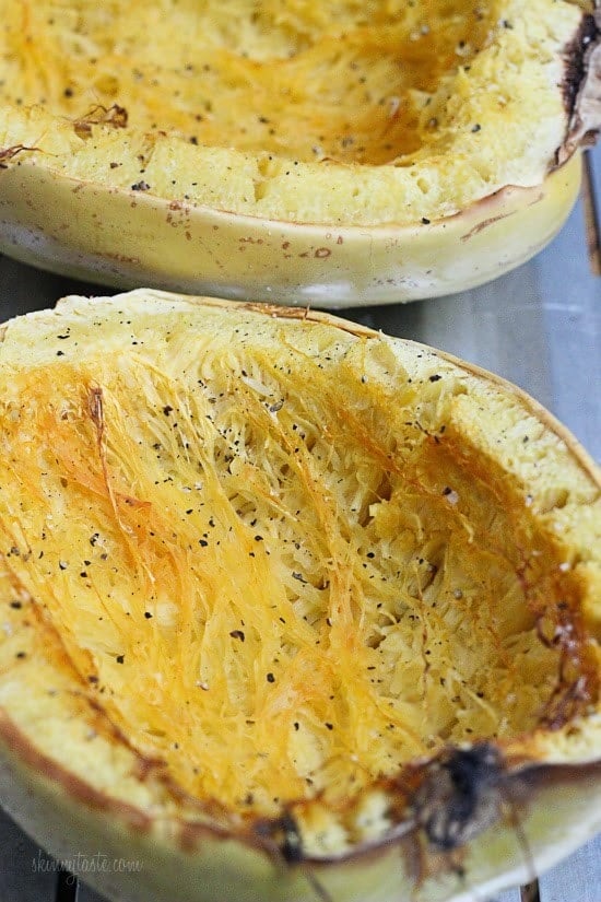 Two roasted halves of spaghetti squash