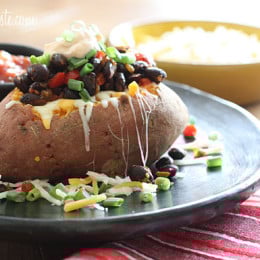 Loaded Vegetarian Baked Sweet Potato are Mexican-inspired, loaded with zesty black beans, melted cheese, salsa with a dollop of cream. What can be better than a 20 minute meal!