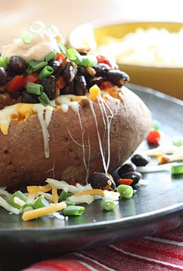 Loaded Vegetarian Baked Sweet Potato are Mexican-inspired, loaded with zesty black beans, melted cheese, salsa with a dollop of cream. What can be better than a 20 minute meal!