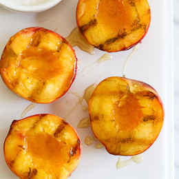 Nothing says summer like biting into a juicy peach. Grilling them is a simple way to enjoy them as a dessert, a perfect ending to a backyard BBQ without heating up your kitchen. Delicious topped with yogurt and honey, but also great topped with low fat ice cream.