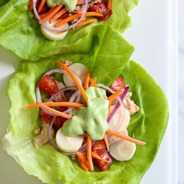 This low-calorie, low-carb tuna lettuce wrap with avocado yogurt dressing transforms ordinary canned tuna into a tasty light lunch filled with hearts of palm, tomatoes, carrots and onion.