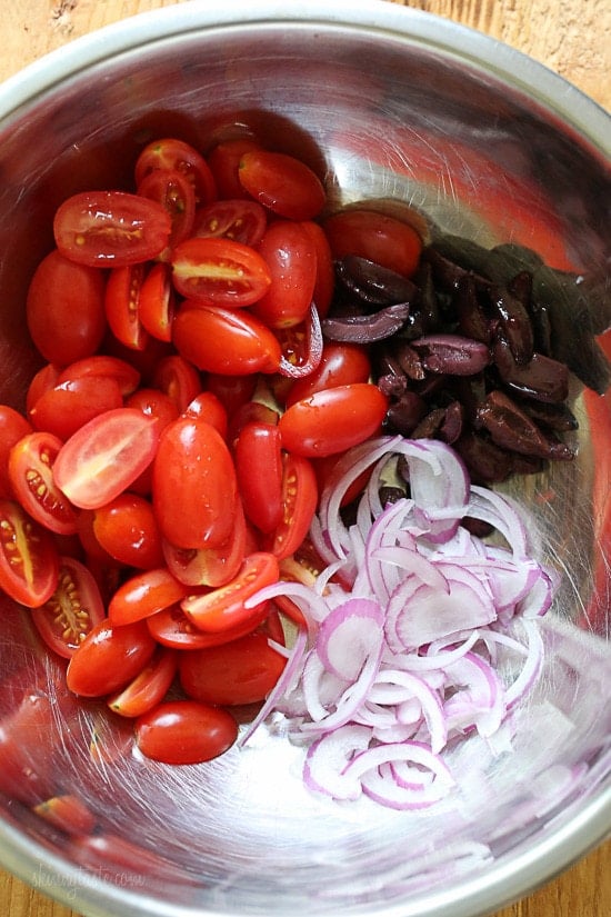 Grilled wild Mediterranean cedar plank salmon topped with tomatoes, kalamata olives and red onion.