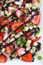 This easy light summer salad, made with cucumbers, strawberries, almonds and fresh herbs is great alongside grilled chicken, fish or for a light lunch you can double the serving and add some goat cheese to the mix or serve it over quinoa for more protein.