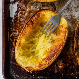fork shredding strands of spaghetti squash