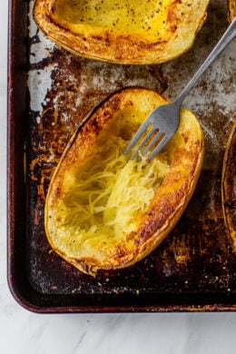 fork shredding strands of spaghetti squash