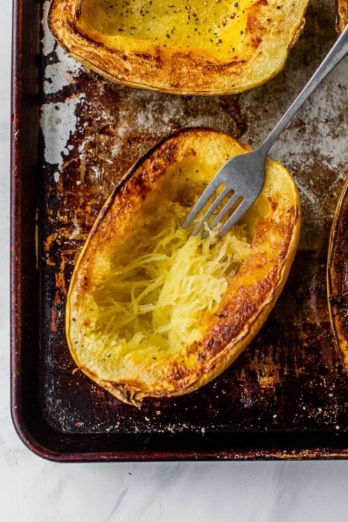 fork shredding strands of spaghetti squash