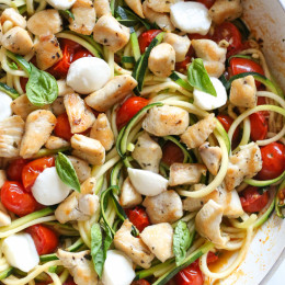 Chicken and Zucchini Noodle Caprese is made with sauteed bite-sized chicken breast and grape tomatoes cooked with spiralized zucchini, fresh mozzarella and basil. An easy, low-carb 30-minute meal!