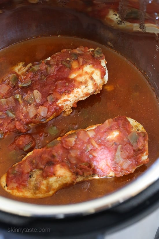 Instant Pot salsa chicken is so quick and easy! Make this juicy 2-ingredient shredded chicken to use in tacos, rice bowls, salads, and more. Cooked salsa chicken inside the Instant Pot.