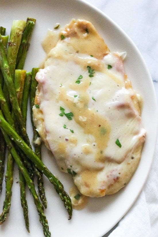 This EASY Skillet Chicken Cordon Bleu is made with thin sliced boneless chicken cutlets, lightly pan fried then topped with ham and swiss in a light Lemon-Dijon Sauce. No rolling!