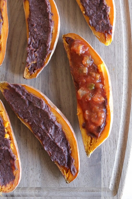 These cheesy baked sweet potato skins are loaded with fat free black refried beans, salsa and cheddar cheese. Just a few ingredients but they taste SO good!
