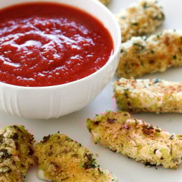 Hot baked mozzarella sticks – I can't think of a more popular finger food for both kids and adults alike. My oldest daughter Karina LOVES them and these never disappoint! Made lighter with part-skim mozzarella then coated with crispy seasoned breadcrumbs and baked (not fried!) until hot and golden. Serve them with my quick marinara sauce and you have yourself an appetizer everyone will love!