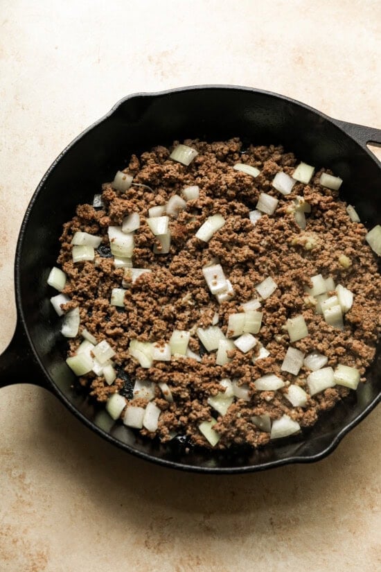 An easy and delicious Korean beef recipe is made with ground beef, served over rice with cucumbers and gochujang sauce. Cook the ground beef, add onions and garlic.