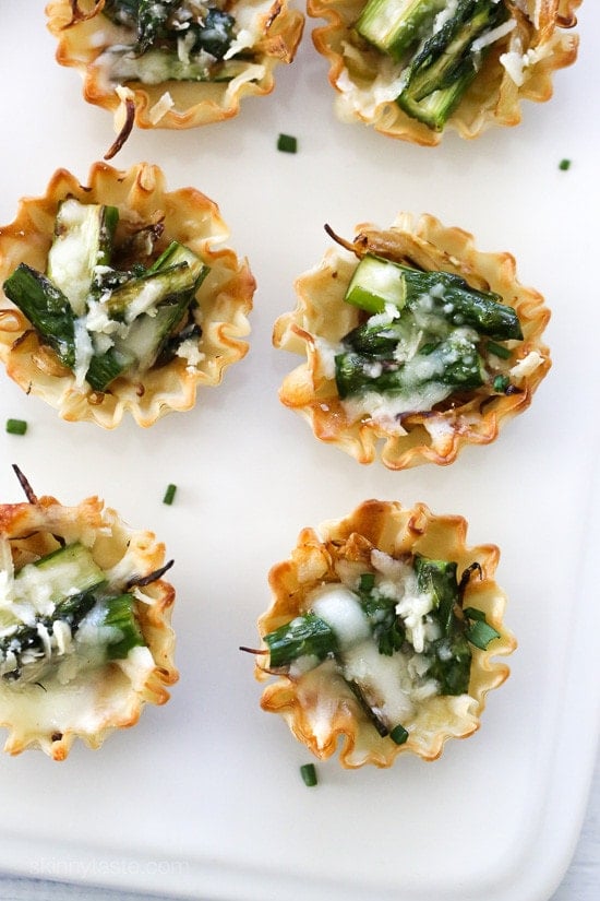 Asparagus and Caramelized Onion Tartlets make a tasty appetizer for Easter! These bite-sized asparagus tartlets are SO so good, made with a combination of caramelized onion, cheese and asparagus, they are ridiculously easy to make thanks to the mini phyllo pastry shells. You can prep everything ahead and assemble, then bake it in the oven just before ready to serve.