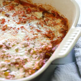 Layers of eggplant, zucchini and squash are baked in a quick tomato sauce with bell peppers and herbs then topped with Havarti cheese. This is a great tasting meatless main dish.