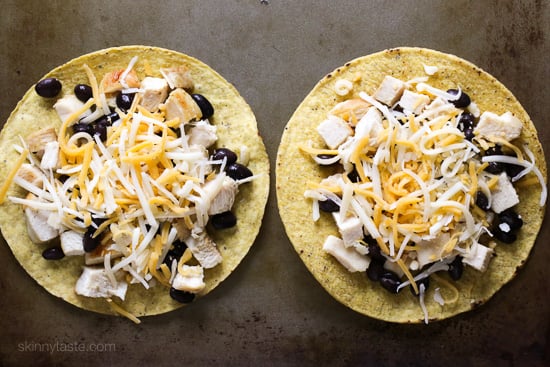 These easy loaded chicken "nacho" tostadas – topped with cheese, tomatoes, guacamole, olives and jalapenos are a great way to take nachos and turn them into a main dish.