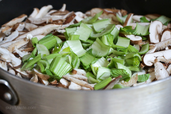 Mushrooms and bok choy in a pan.