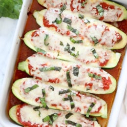 These low-carb Veggie Lasagna Zucchini Boats are basically hollowed out zucchinis stuffed with a veggie lasagna filling and baked in the oven with marinara sauce and melted cheese – SO GOOD!