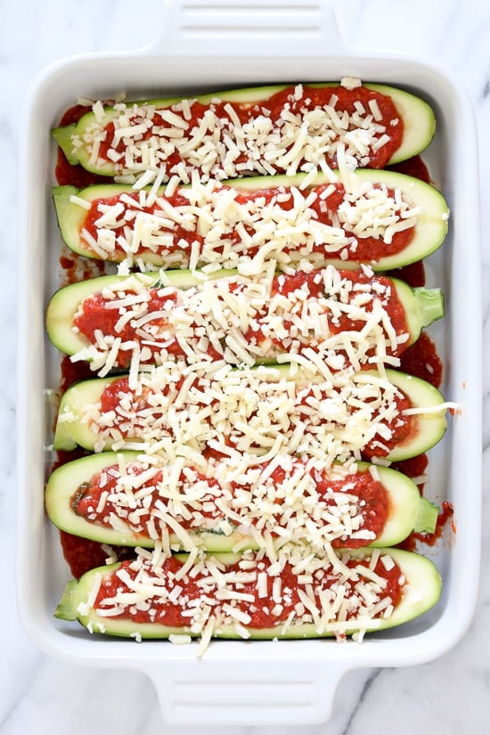 These low-carb Veggie Lasagna Zucchini Boats are basically hollowed out zucchinis stuffed with a veggie lasagna filling and baked in the oven with marinara sauce and melted cheese – SO GOOD!