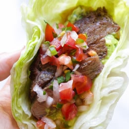 Grilled sirloin steak "flaco" tacos use lettuce wraps instead of tortillas! The steak is seasoned with cumin and spices, then grilled and sliced thin, along with guacamole and pico de gallo – low-carb and super delicious!
