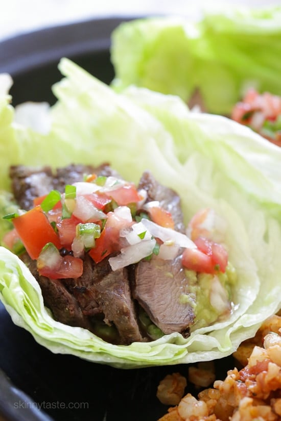 Grilled sirloin steak "flaco" tacos use lettuce wraps instead of tortillas! The steak is seasoned with cumin and spices, then grilled and sliced thin, along with guacamole and pico de gallo – low-carb and super delicious!