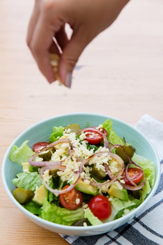 This salad has everything I love about a cheeseburger, sans the bun. Chopped romaine, tomatoes, avocado, pickles, shredded cheese topped with grilled burgers, red onions and drizzled with a seriously delicious dressing.
