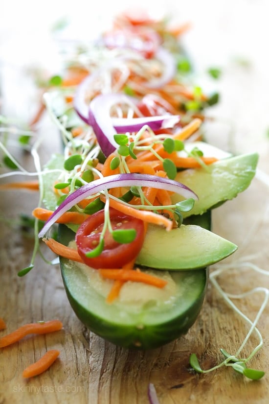 Cucumbers with the seeds scooped out and filled with hummus, avocado, tomatoes, onion and sprouts. So refreshing, healthy and light!