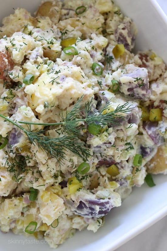 This creamy potato salad made with rainbow potatoes, celery, pickles, and dill is lightened up using half mayonnaise, half yogurt. Perfect for picnics and backyard parties all summer long.