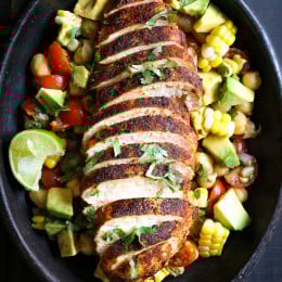 Blackened Chicken over a flavorful chickpea salad with fresh corn, tomatoes, avocado and lime juice. A quick and easy weeknight dish!