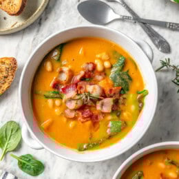 Overhead view of navy bean soup with bacon and spinach