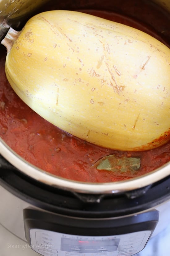Make this easy, healthy Spaghetti Squash AND Meat Sauce all at the same time with this delicious one-pot meal ready in under thirty minutes when made in the pressure cooker or slow cooker! This is the easiest way to make spaghetti squash whole, no cutting before it's cooked, just poke some holes all over and cook it!