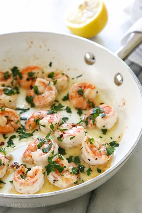 Shrimp scampi in a bright white skillet.